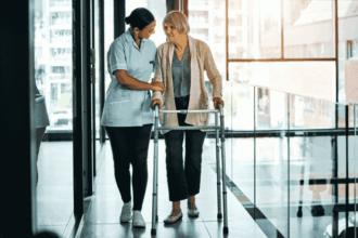 Caregiver assisting a senior woman with a walker, symbolizing specialized and extended care services, including elderly care and daily living assistance.