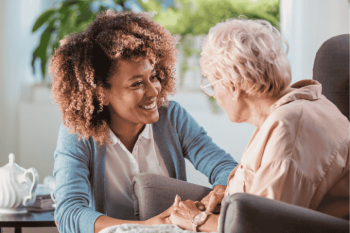Caregiver providing companionship and supportive care to a senior in a warm, caring environment, ensuring emotional well-being.Caregiver providing companionship and supportive care to a senior in a warm, caring environment, ensuring emotional well-being.