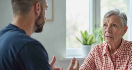Home care services provider discussing personalized in-home care and support solutions with a senior client in Hamilton.